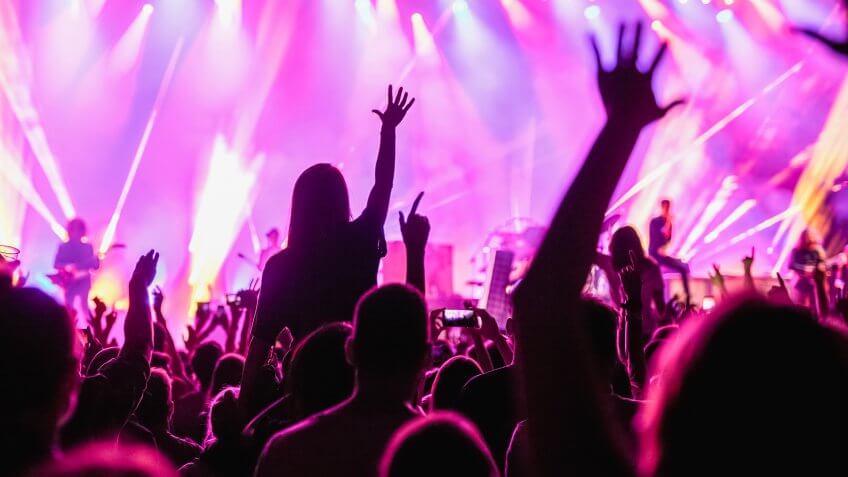 Crowd raising hands in the air on the music festival.