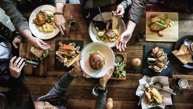 Friends all together at restaurant having meal - Image.