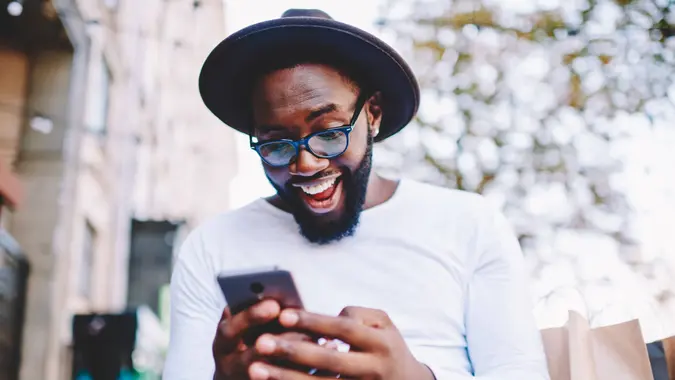 excited guy using smartphone