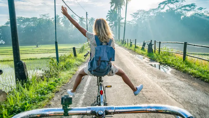 Personal perspective of cheerful young couple cycling in the country side of Indonesia, Borobudur, Central Java, Indonesia.