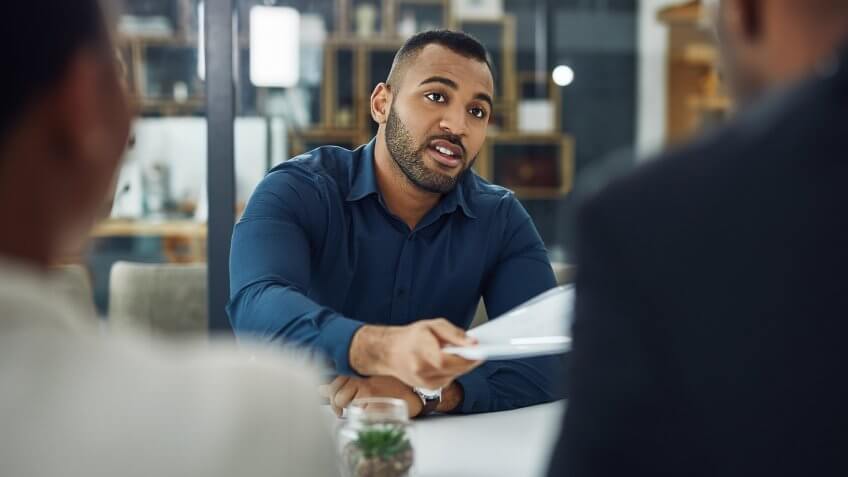 Cropped shot of a handsome young businessman sitting in the boardroom during his job interview.