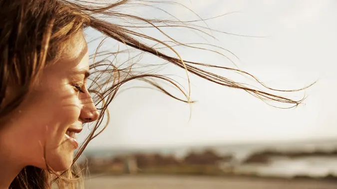 Cropped view of a young woman with the wind in her hair.
