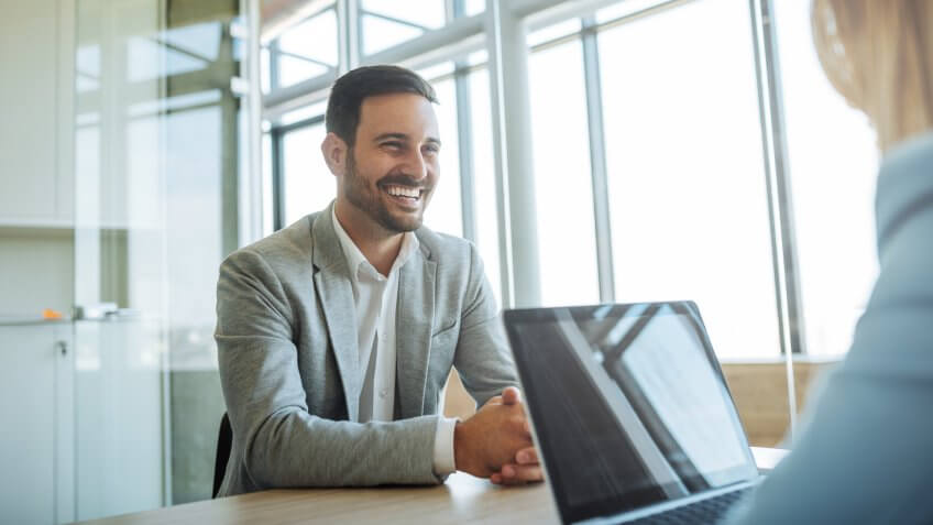 Young man smiling during a job interview.