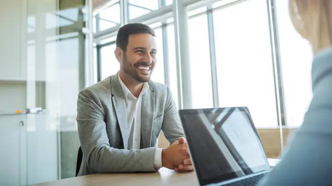 Young man smiling during a job interview.