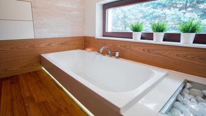 Large white bathtub Picture of large white bathtub in wooden bathroom.