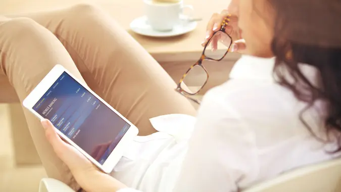 Businesswoman reading information about her bank account on the Internet.
