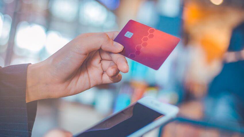 Business woman hand use credit cards and smartphones.