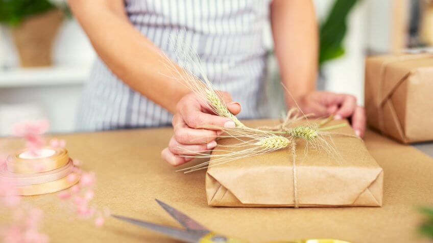 woman wrapping holiday gift