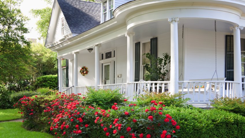 Southern Alabama home with beautiful porch and lovely red roses.