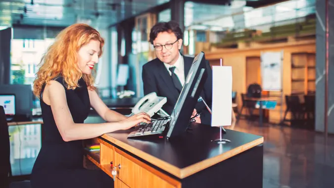 Bank receptionist helping customer, businessman.