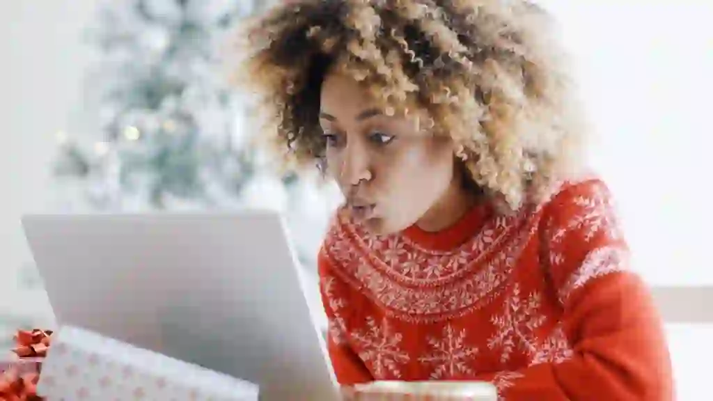 Excited woman shopping online for Christmas bargains
