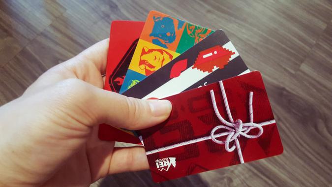 Colorful gift cards in person's hands