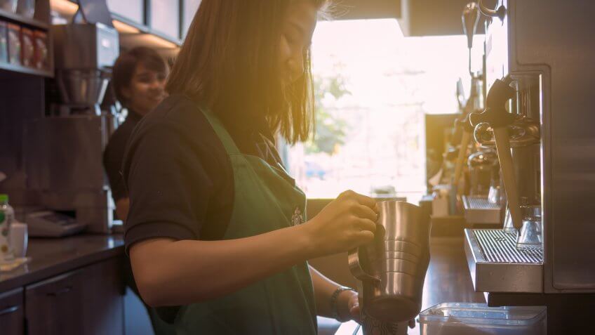 Starbucks barista making a coffee drink