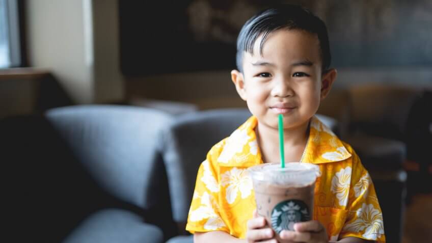 starbuck coffee at Bangkok,Thailand : 13 april 2017 : Asian baby boy holding and surf coffee.
