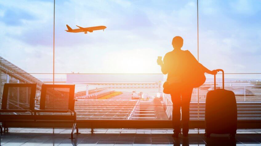 happy traveler waiting for the flight in airport, departure terminal, immigration concept.