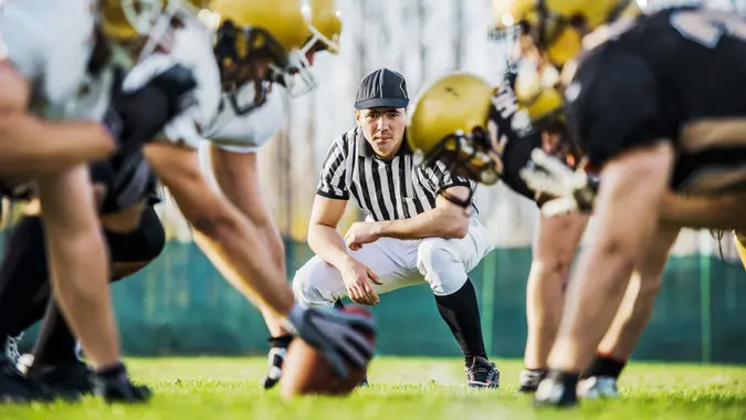 male football referee on line of scrimmage