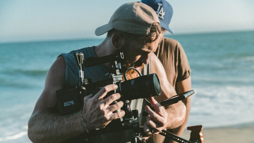cameraman working freelance job on the beach