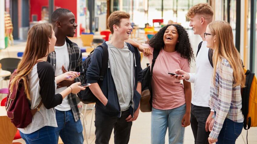 Student Group Socializing In Communal Area Of Busy College.