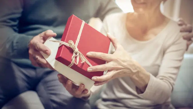 Senior man giving present to his wife.