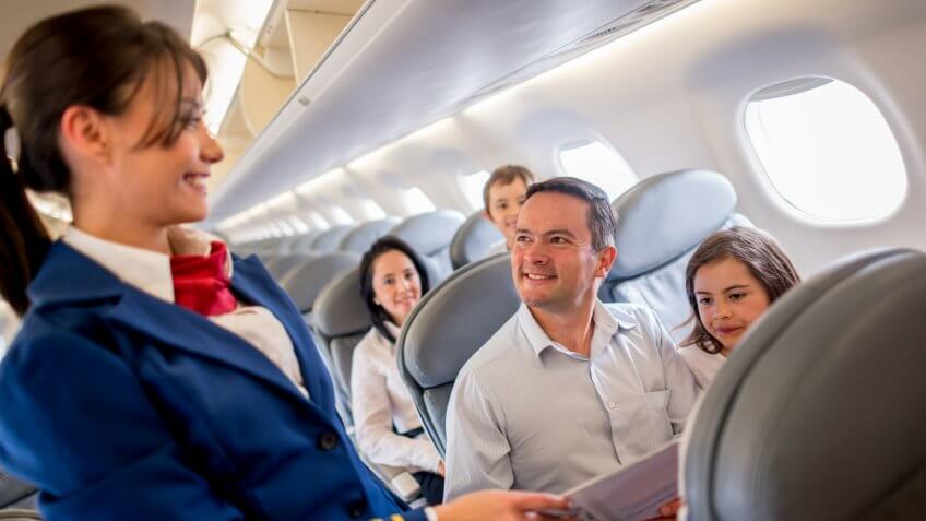 Family traveling by plane and enjoying the service onboard.