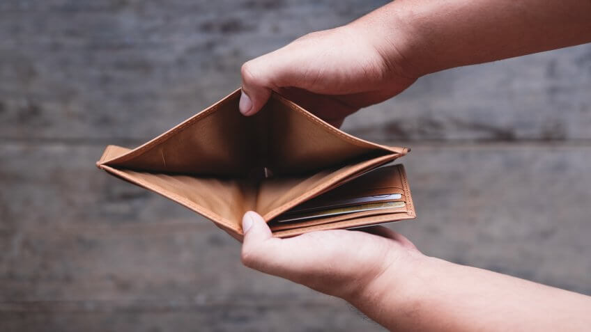 Hand opening empty wallet.