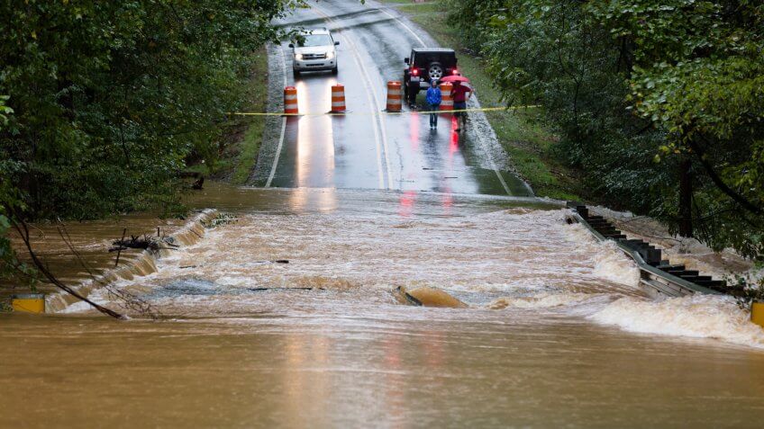 Waxhaw, North Carolina - September 16, 2018: Motorists inspect a road flooded by rain from Hurricane Florence.