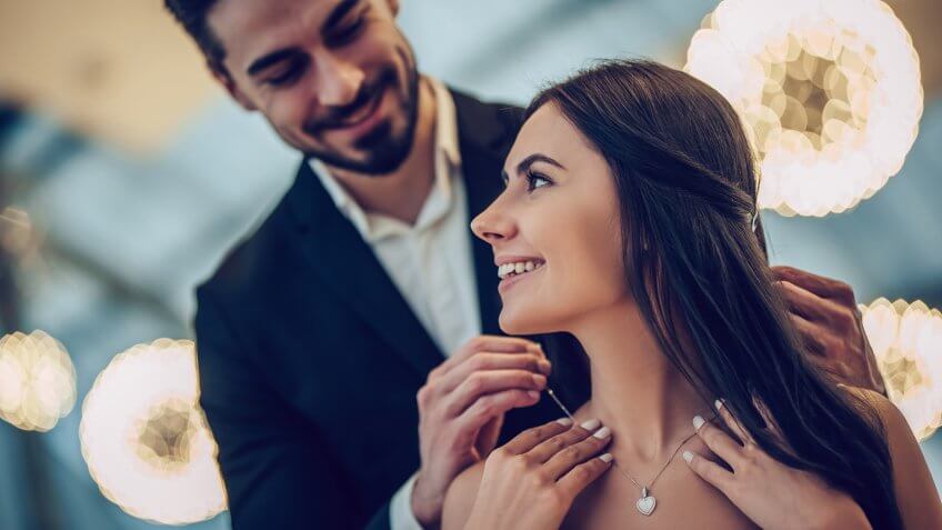 Beautiful loving couple is spending time together in modern restaurant.