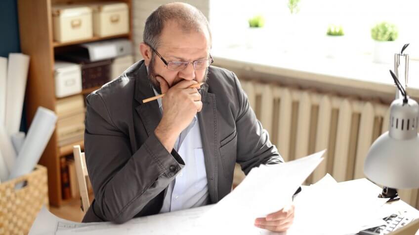 Mature Adult man working in the office.