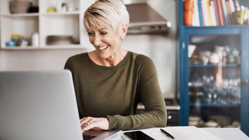 Shot of a mature woman working on a laptop at home.