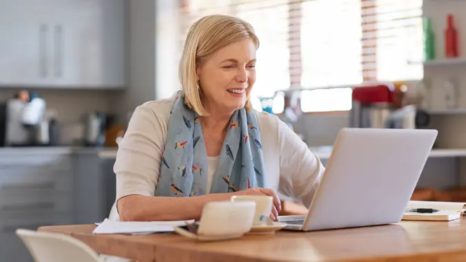 Shot of a mature woman using a laptop to do her finances at homehttp://195.