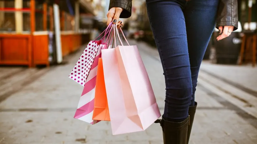 woman walking with shopping bags during holidays