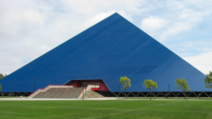 Long Beach, California USA - May 11, 2018: Walter Pyramid sports arena north face on the campus of the state University, set back from Atherton Street by a wide lawn of green grass.