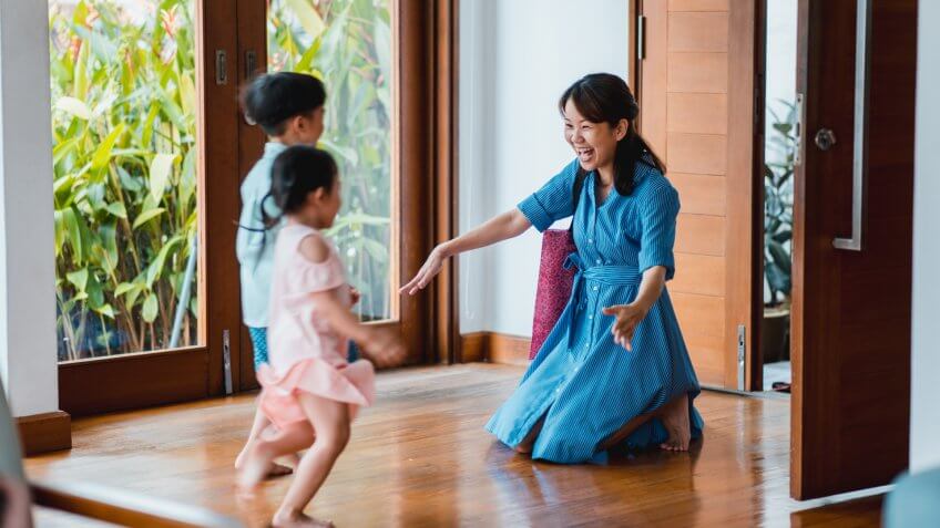 Children running to their mother when she comes home.