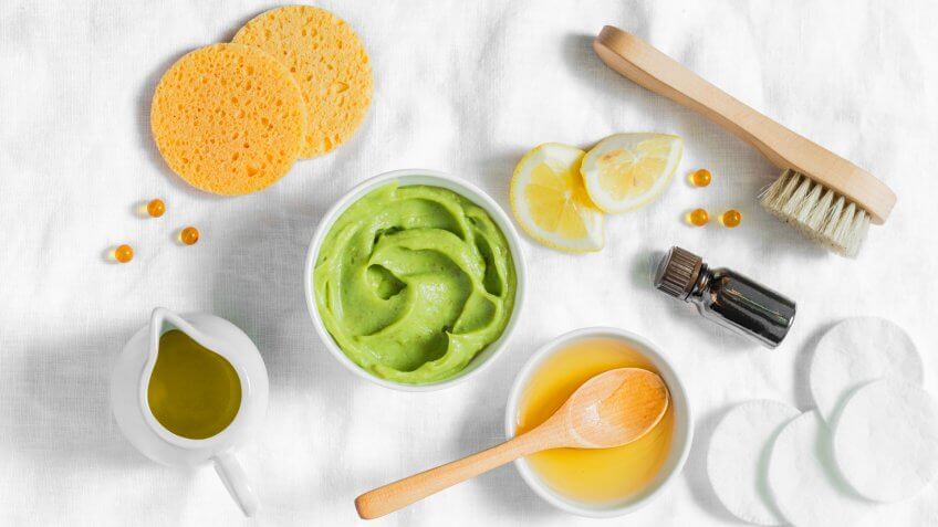 Honey and avocado face mask on light background, top view.