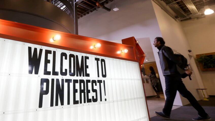 Photo by Jeff Chiu/AP/REX/Shutterstock A man walks past a sign at the Pinterest office in San Francisco, .