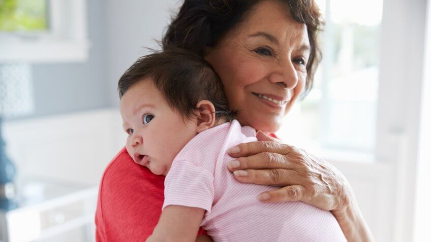 Proud Grandmother Holding Baby Granddaughter.