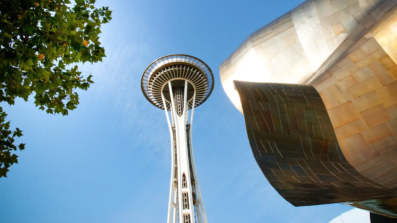 "Seattle, United States - September 19, 2011: Space Needle is a tower and a symbol of Seattle, the tower is located in Seattle Center, which is a cultural center and in this square there is also the interactive museum of music with its irregular structure and futuristic".
