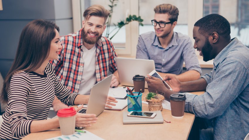 Start-up multiethnic entrepreneurs working on their project in coworking atmosphere.