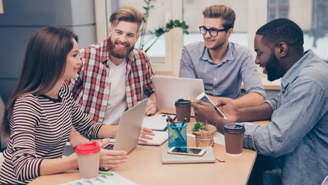 Start-up multiethnic entrepreneurs working on their project in coworking atmosphere.