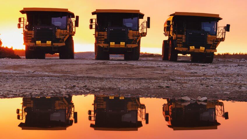 Dump truck at a construction site at sunset.