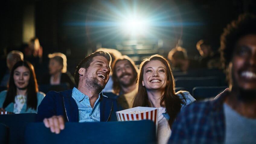 Close up of a couple enjoying a movie in the cinema.