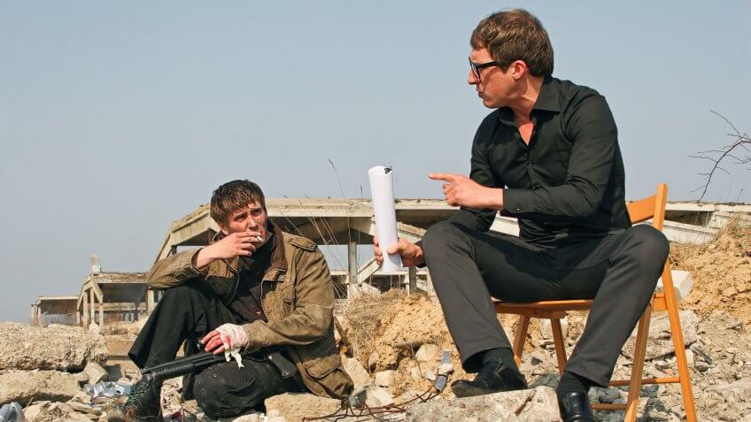 director talking with actor on set