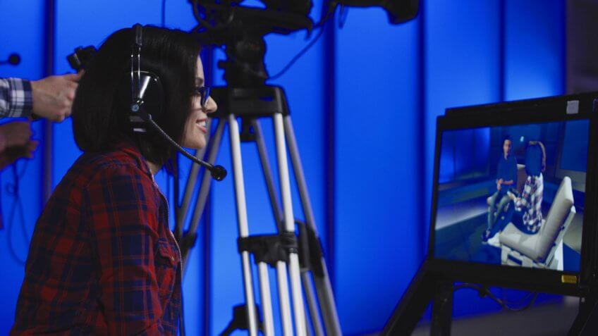 female art director watching set on monitor