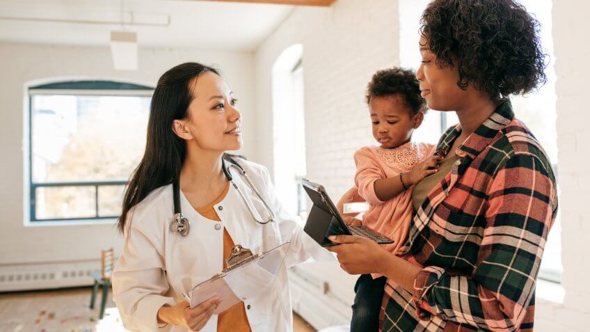 Family doctor attending toddler.