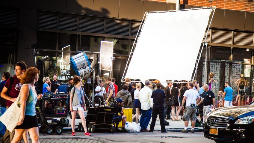 New York City, New York, United States - August 21, 2014: Cameramen and crew setting up a shoot on street in Chelsea, New York for a movie set.