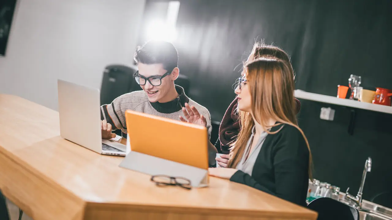 Colleagues working on the coffe break in the office kitchen.