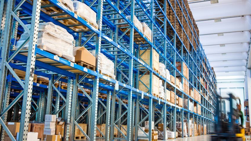 Modern storehouse with forklift truck loader.