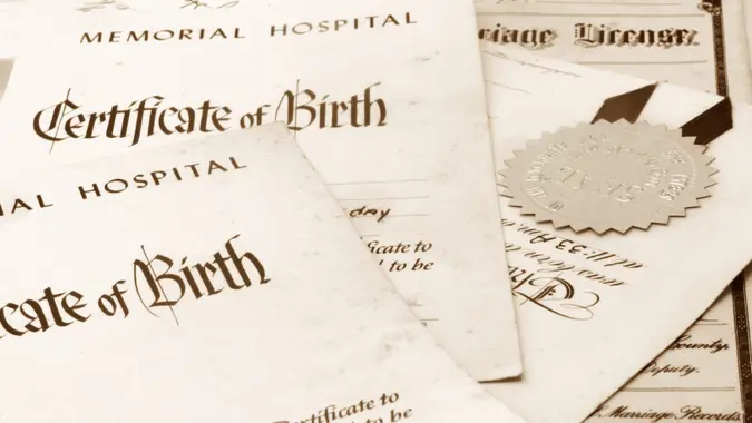 Close-up of a stack of important family papers including birth certificates and marriage license.