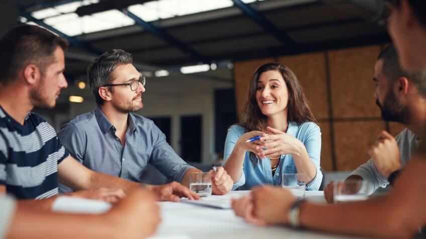 Shot of a group of coworkers having a meeting in an open plan officehttp://195.