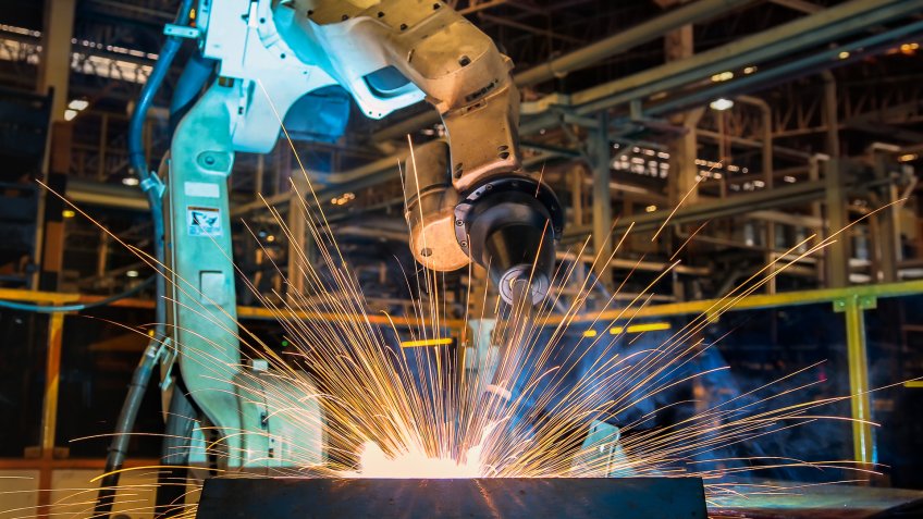 Industrial robot is test run welding in car factory.